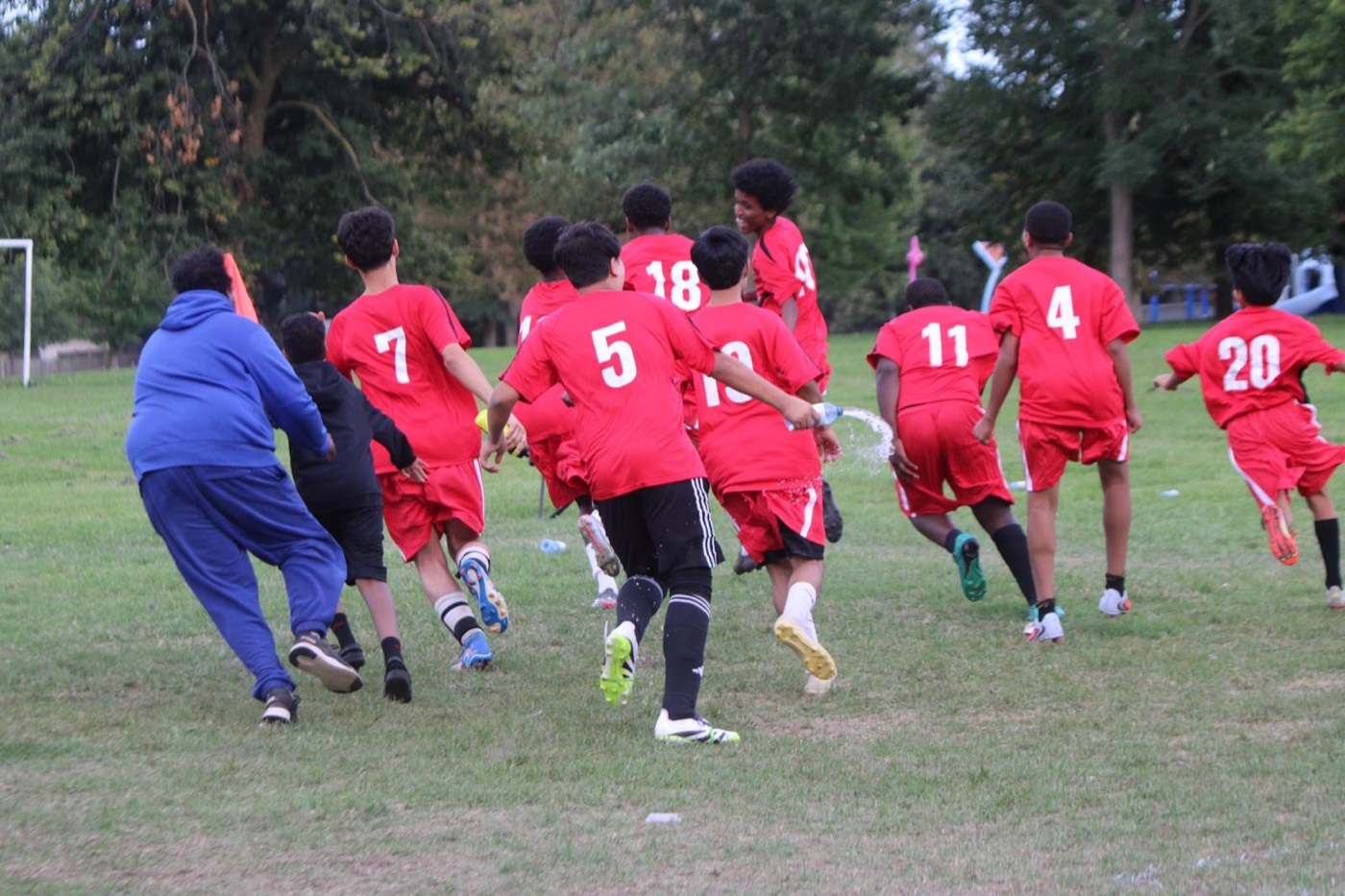 Dixon FC players run to celebrate a win